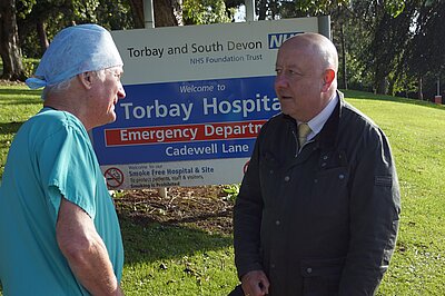 Steve Darling MP talking to a medic outside Torbay Hospital